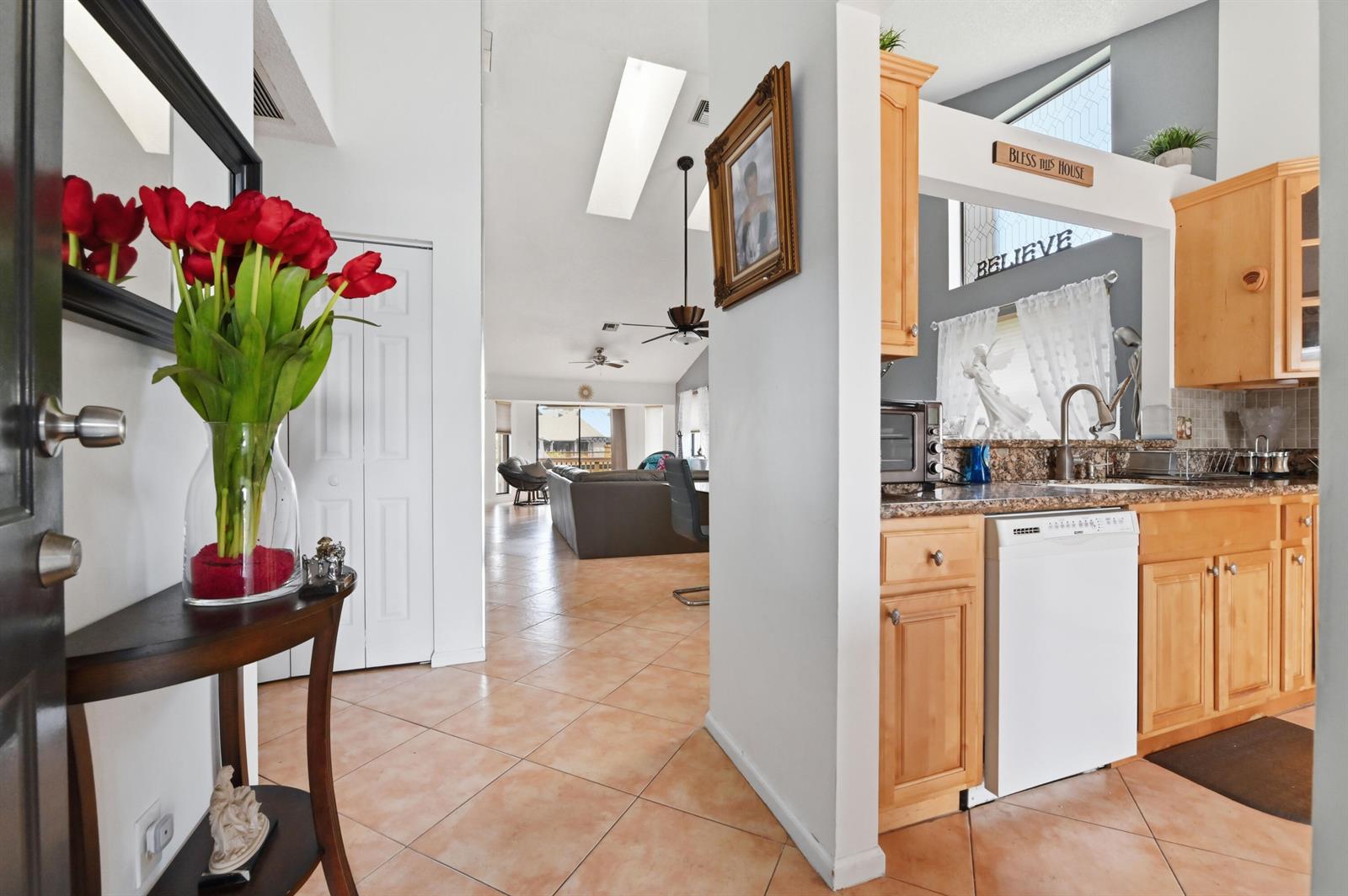 A view from an entryway looking into a living area with a kitchen on the right — 1012 Landings Boulevard, FL 33413, FL