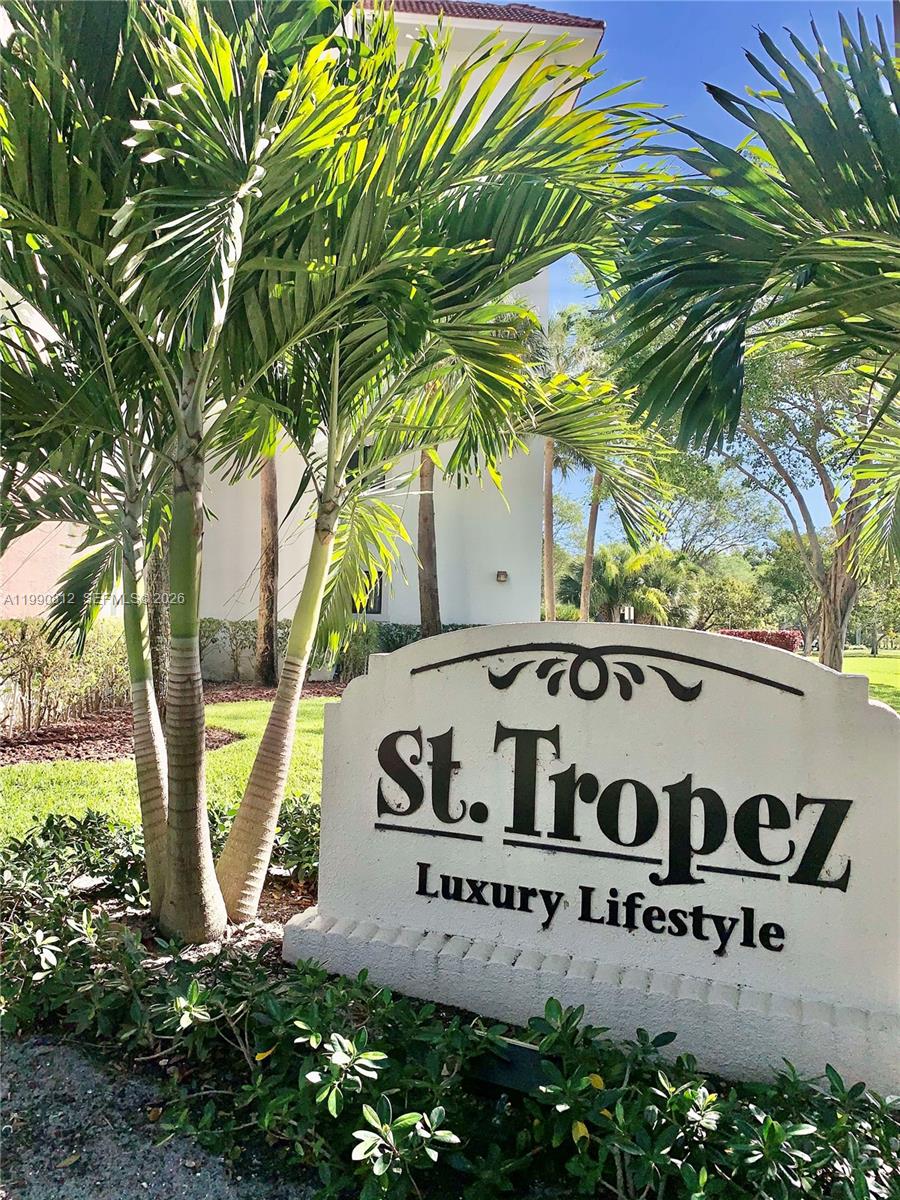 A sign reading St. Tropez Luxury Lifestyle stands in front of palm trees and buildings — 2105 Lavers Cir # 501, Delray Beach FL 33444, DELRAY BEACH, FL