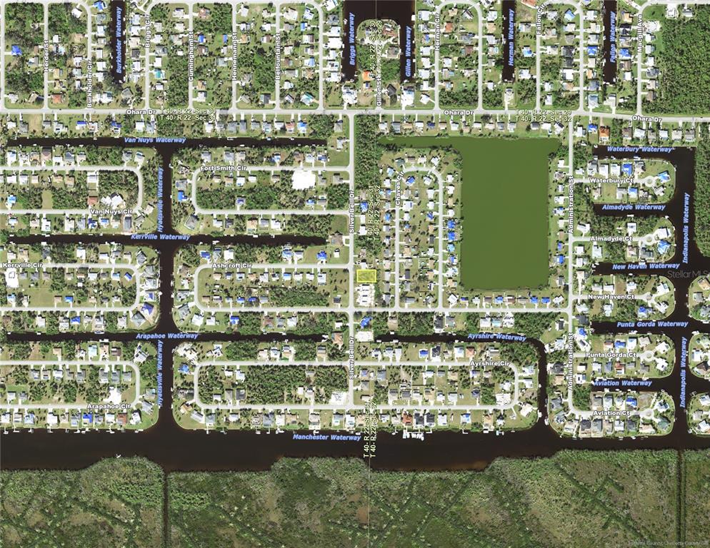 This is an aerial map showing residential streets, waterways, and a vacant lot in Florida — 5112 SILVER BELL DRIVE, PORT CHARLOTTE, FL