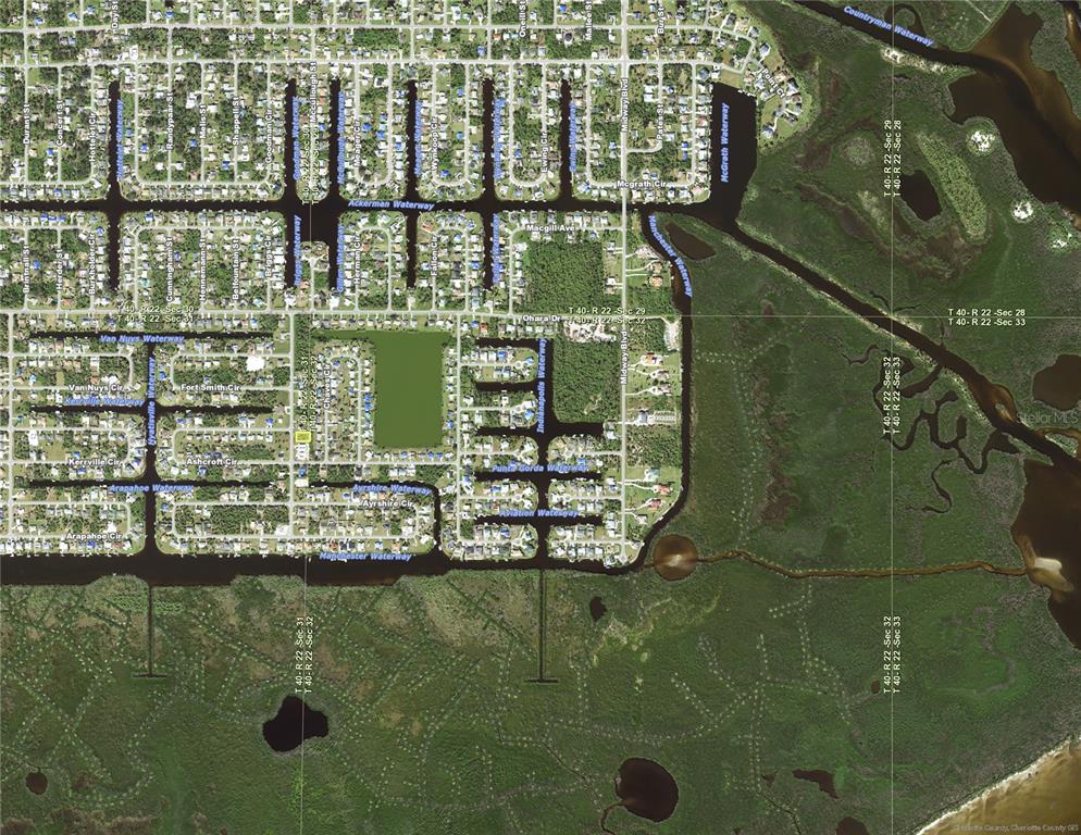 This is an aerial map showing a residential neighborhood with canal systems and surrounding wetlands — 5112 SILVER BELL DRIVE, PORT CHARLOTTE, FL