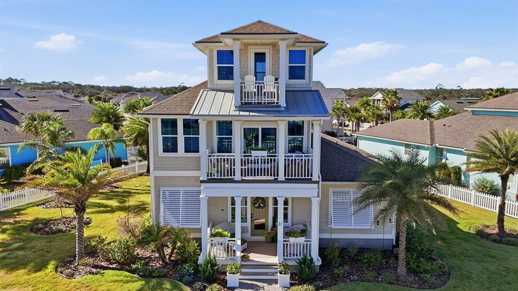 A three-story coastal house features a front porch, a second-story balcony, and a rooftop cupola — 31 BEACH HAVEN PARKWAY, PALM COAST, FL