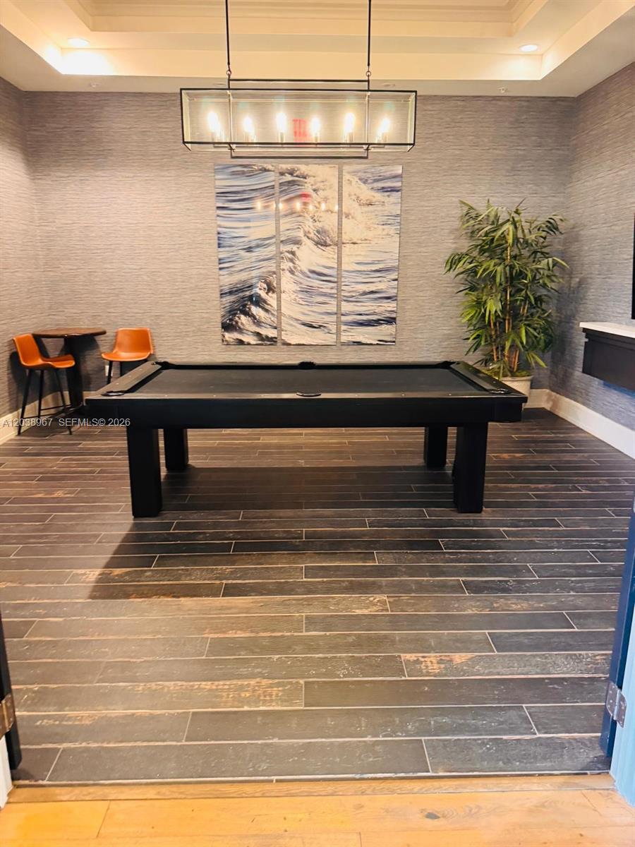 A game room features a black pool table, a rectangular chandelier, and textured gray walls — 5811 CASSIDY LANE, Ave Maria FL 34142, AVE MARIA, FL