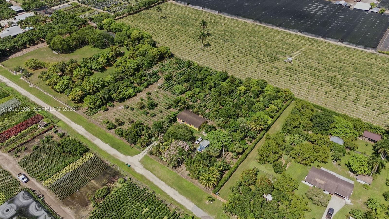 An aerial view shows a house surrounded by dense trees and agricultural fields — 25800 SW 199th Ave, Homestead FL 33031, HOMESTEAD, FL