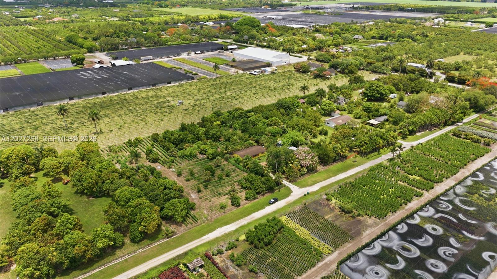 An aerial view shows a rural property with agricultural fields, greenhouses, and a small house — 25800 SW 199th Ave, Homestead FL 33031, HOMESTEAD, FL
