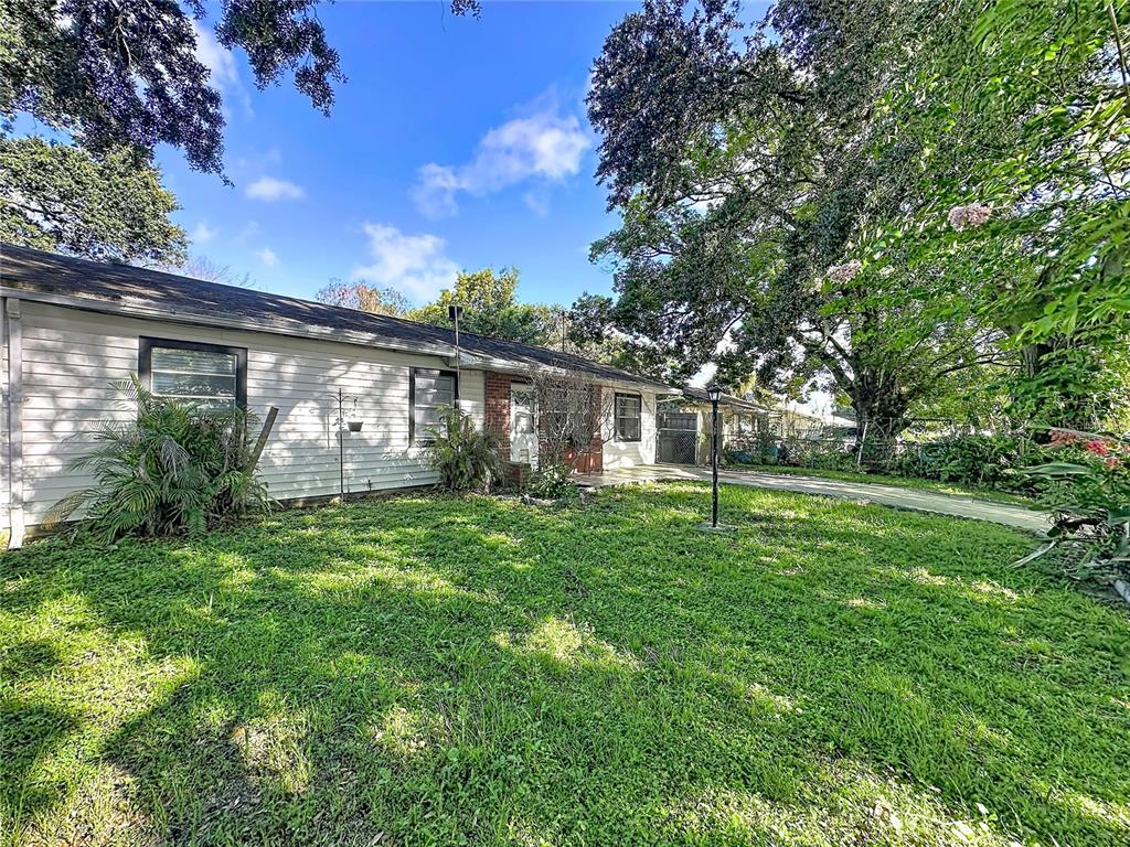 A single-story house with white siding and a brick accent sits behind a grassy lawn — 1520 OVERDALE STREET, ORLANDO, FL