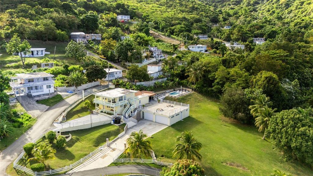 An aerial view shows a two-story house with a pool and garage on a hillside — Carr 3 CAMINO COOPERATIVO, PATILLAS, PR