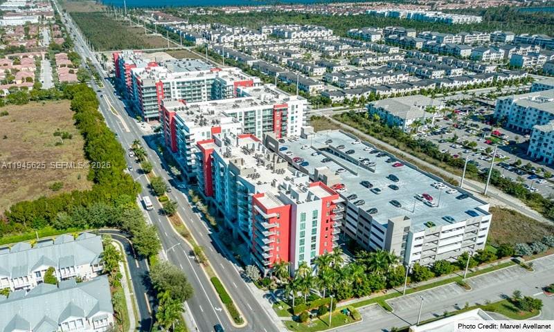 An aerial view shows a large apartment complex with a parking garage and surrounding residential areas — 7875 NW 107th Ave # 819, Doral FL 33178, DORAL, FL