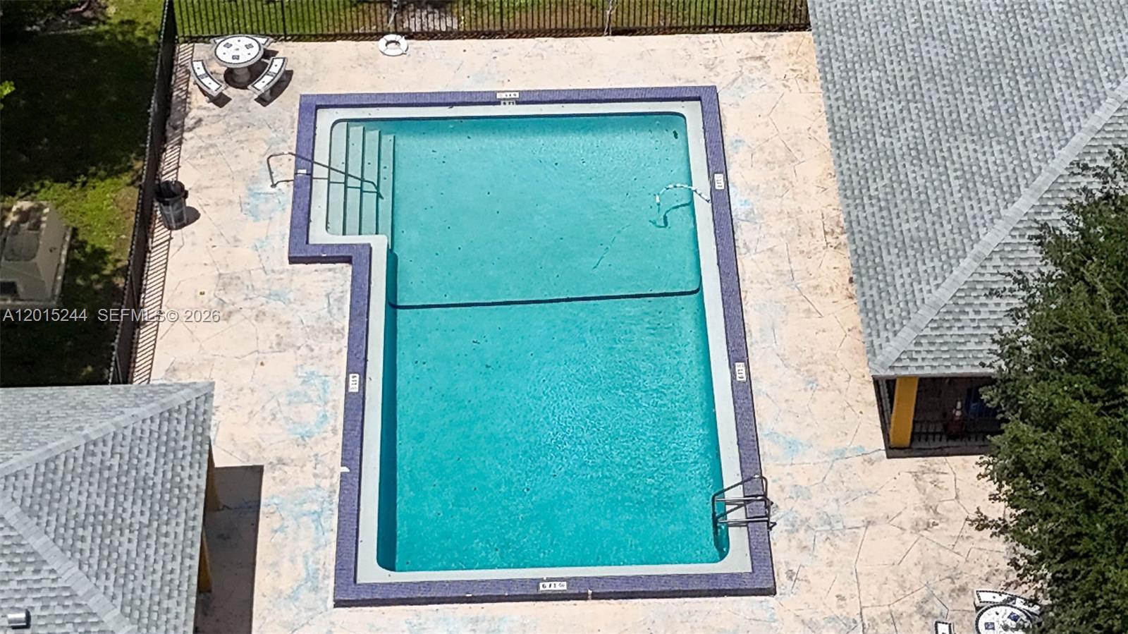 An aerial view shows a rectangular swimming pool with a shallow end and steps — 11790 SW 18th St # 3, Miami FL 33175, MIAMI, FL