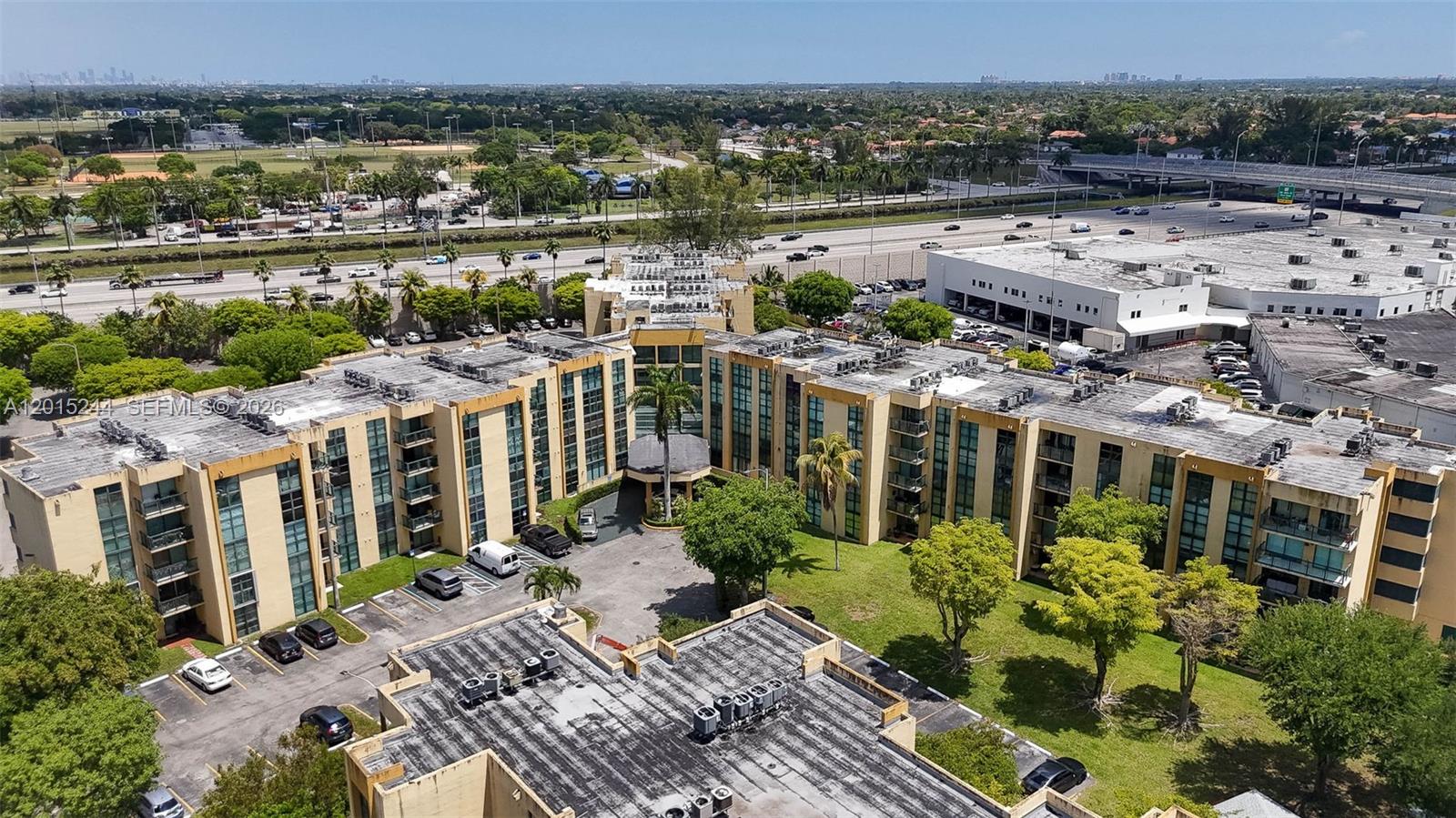 An aerial view shows a multi-story apartment complex with a central courtyard and parking lot — 11790 SW 18th St # 3, Miami FL 33175, MIAMI, FL