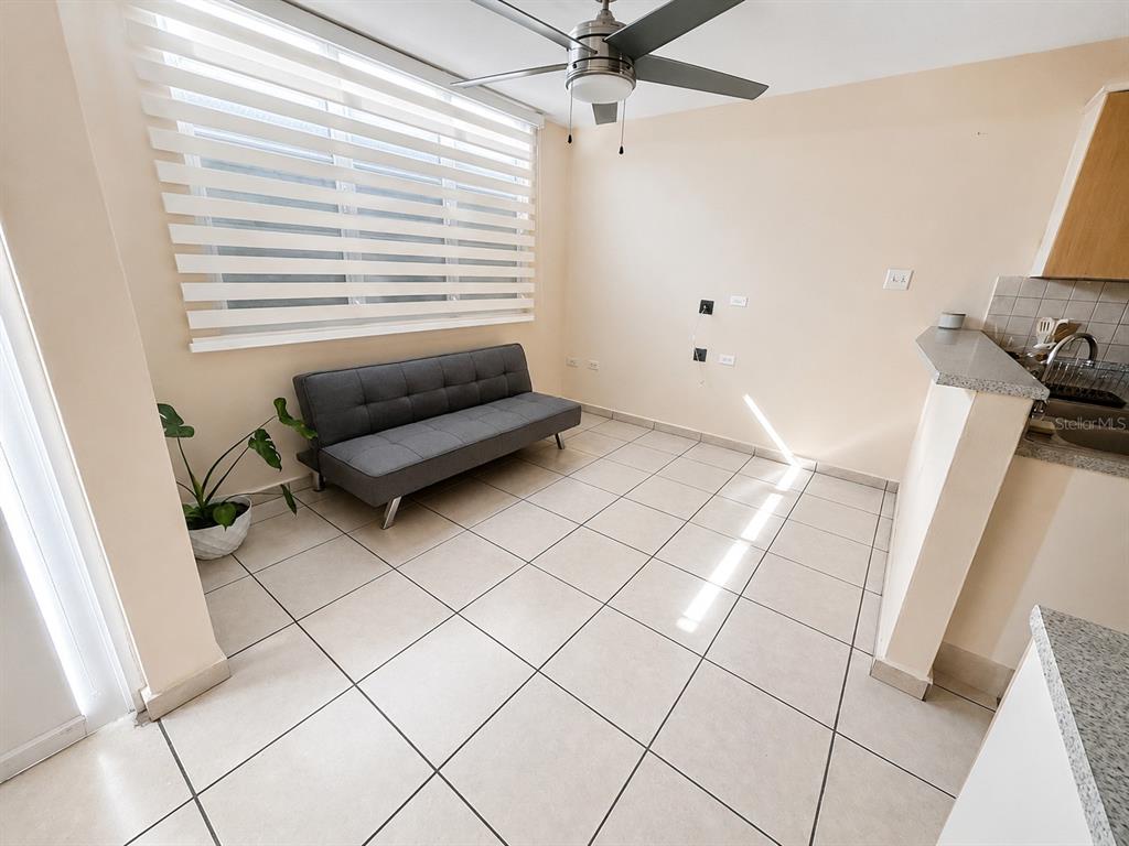 A living area features light tile flooring, a gray sofa, and a ceiling fan — L-143 URB PALACIOS DEL PR CALLE PACIFICO, JUANA DIAZ, PR
