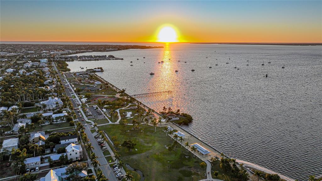 An aerial view of a coastal park and residential area at sunset by the water — 1434 SULSTONE DRIVE, PUNTA GORDA, FL