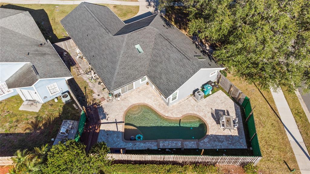 An aerial view shows a house with a gray roof, a pool, and a paved patio — 6500 GROSVENOR LANE, ORLANDO, FL