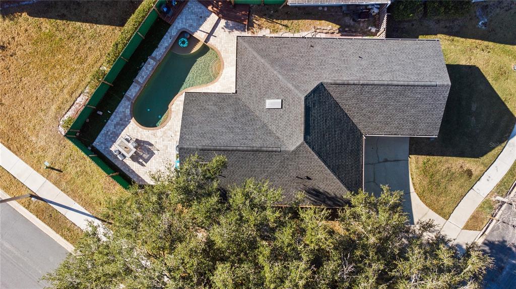 An aerial view shows a house with a dark shingled roof, pool, and patio — 6500 GROSVENOR LANE, ORLANDO, FL