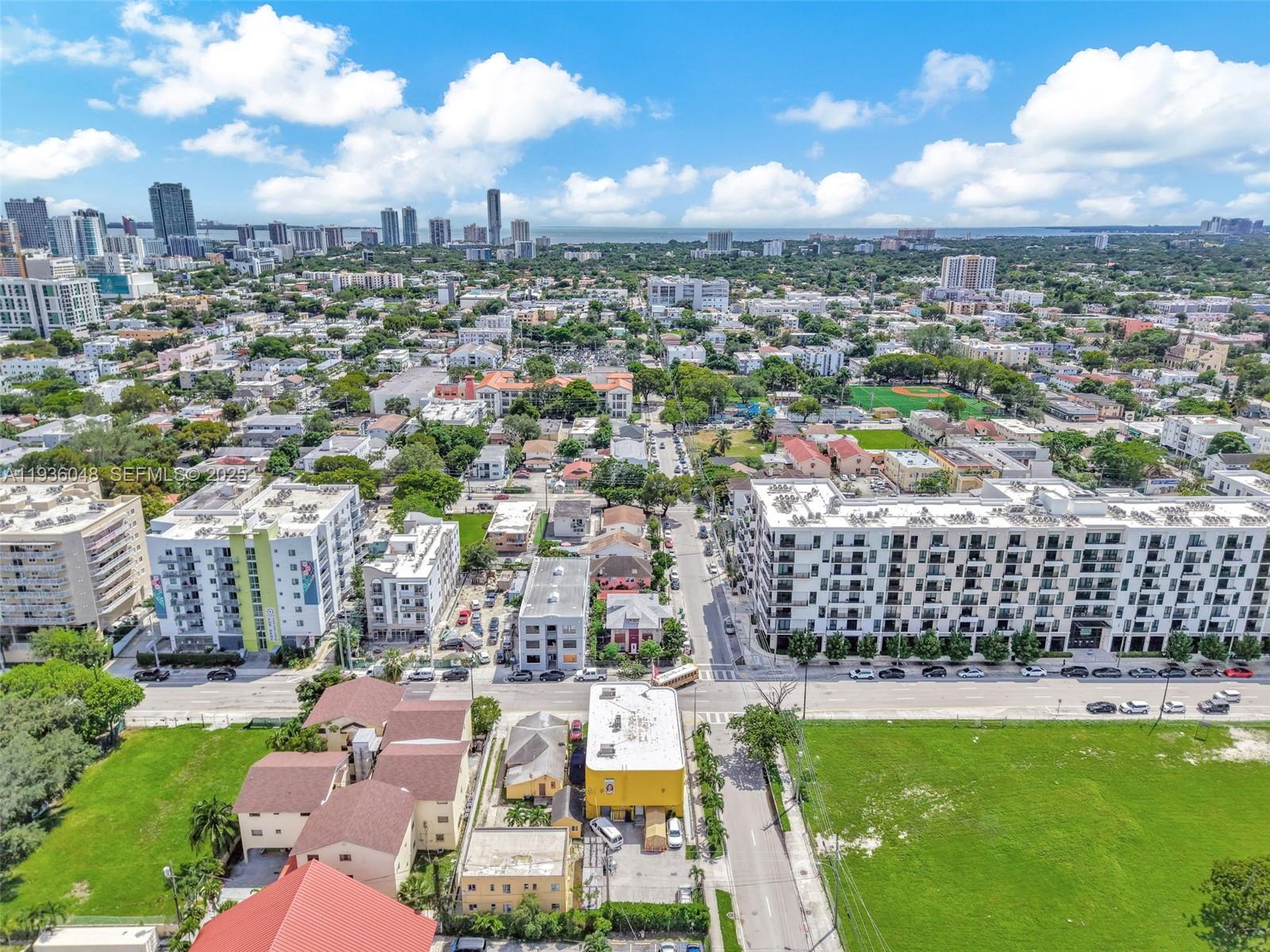An aerial view shows a dense urban neighborhood with apartment buildings, streets, and green spaces — 119 SW 7th Ave, Miami FL 33130, MIAMI, FL