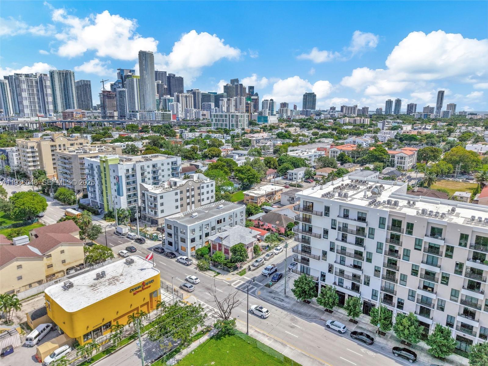 An aerial view shows a city intersection with a yellow building and modern apartment complexes — 119 SW 7th Ave, Miami FL 33130, MIAMI, FL