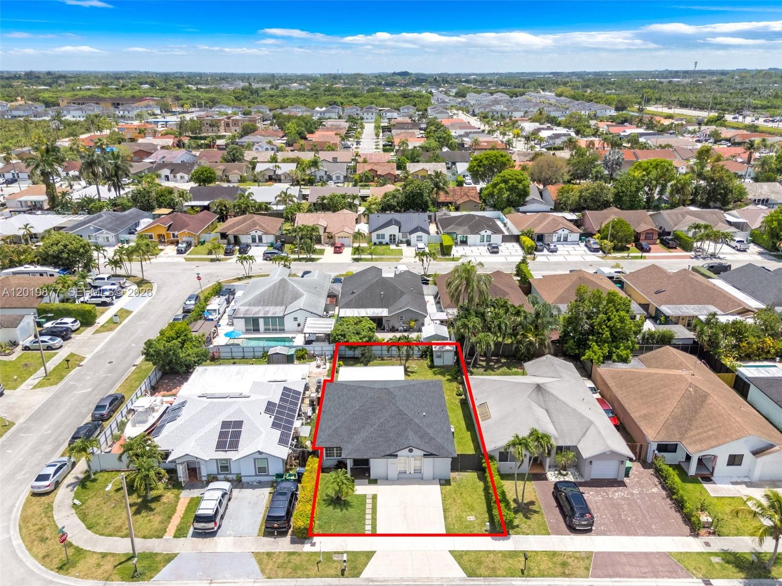 An aerial view shows a single-story house with a dark roof and a red-outlined yard — 13520 SW 180th Ter, Miami FL 33177, MIAMI, FL