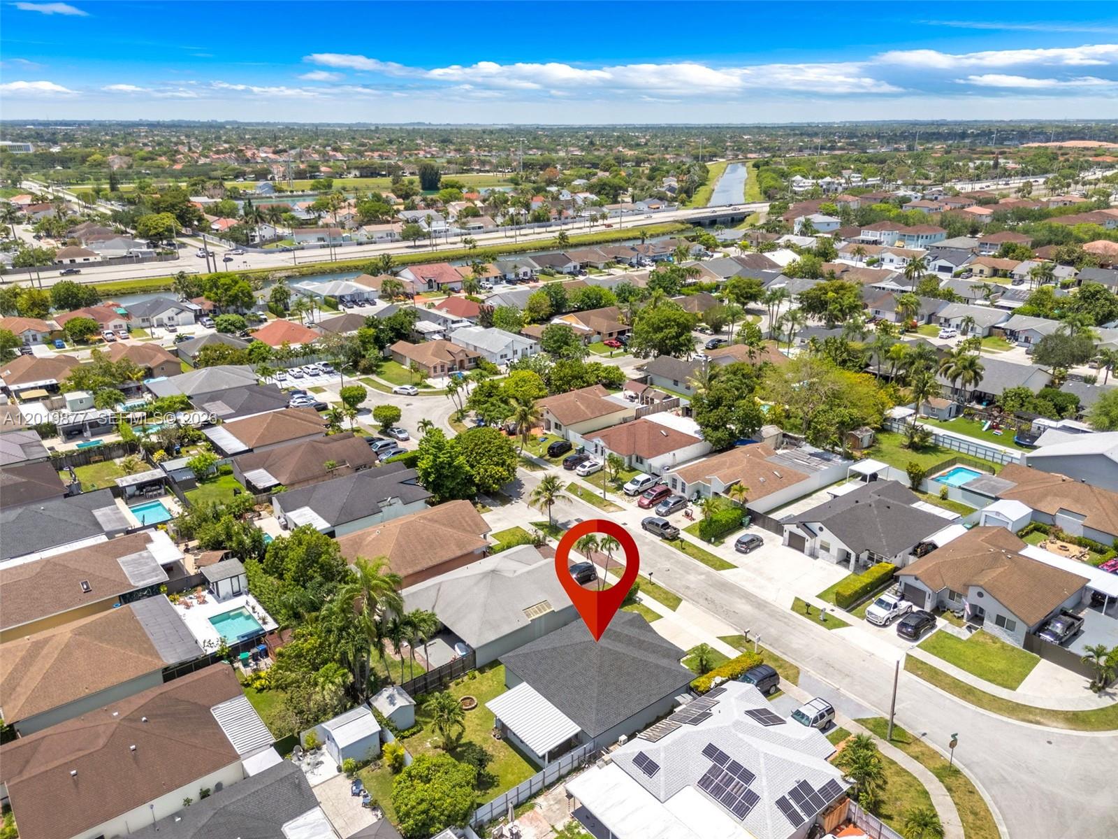 An aerial view shows a residential neighborhood with a red pin marking a house — 13520 SW 180th Ter, Miami FL 33177, MIAMI, FL