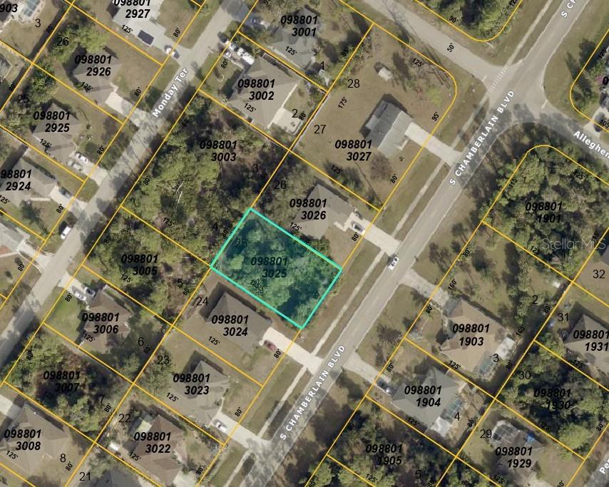 This is an aerial map showing a highlighted vacant residential lot in a suburban neighborhood — S CHAMBERLAIN BOULEVARD, NORTH PORT, FL