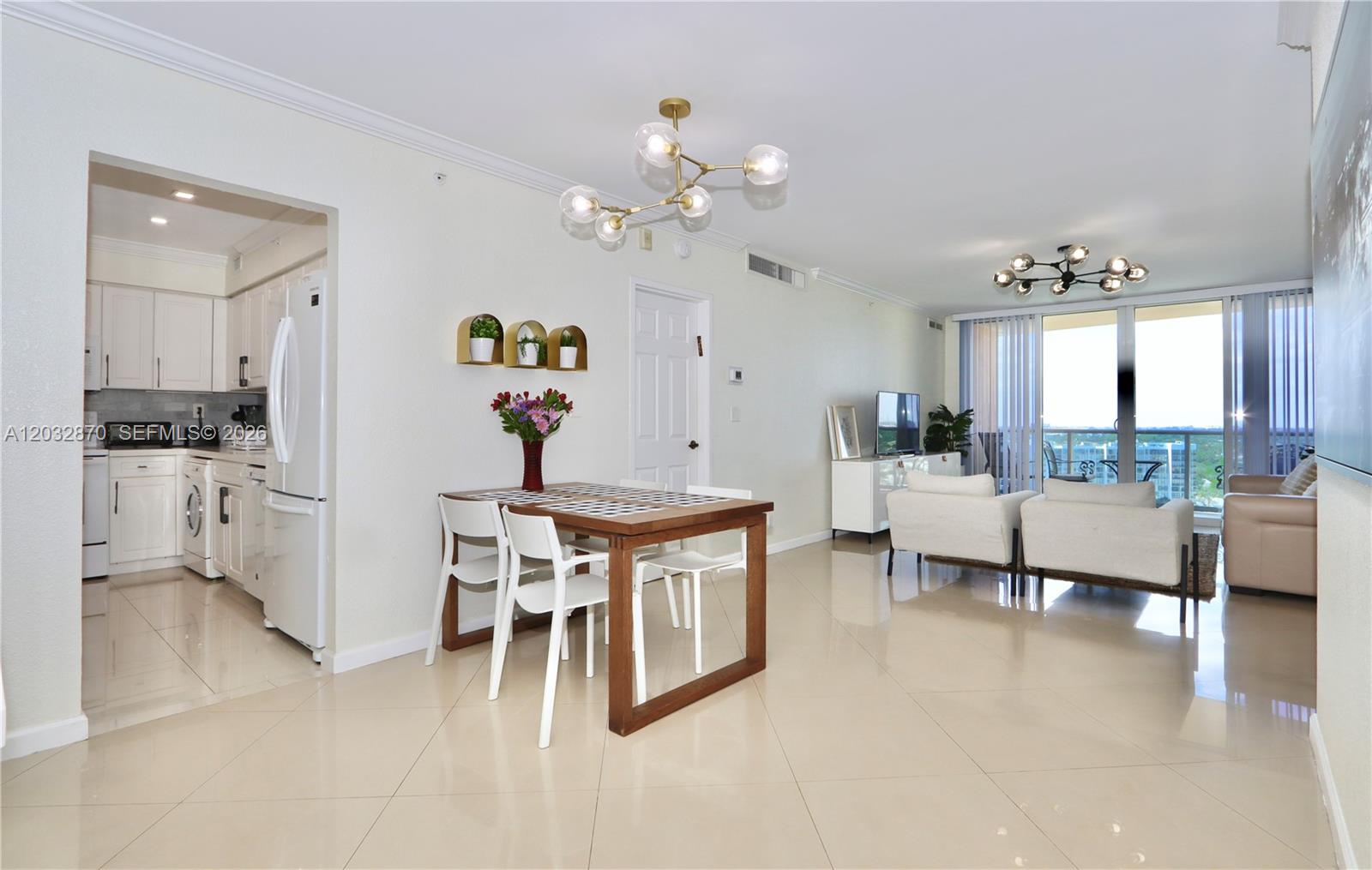 An open-concept living and dining area features tile flooring, modern light fixtures, and a kitchen — 2501 S Ocean Dr # 1430, Hollywood FL 33019, HOLLYWOOD, FL