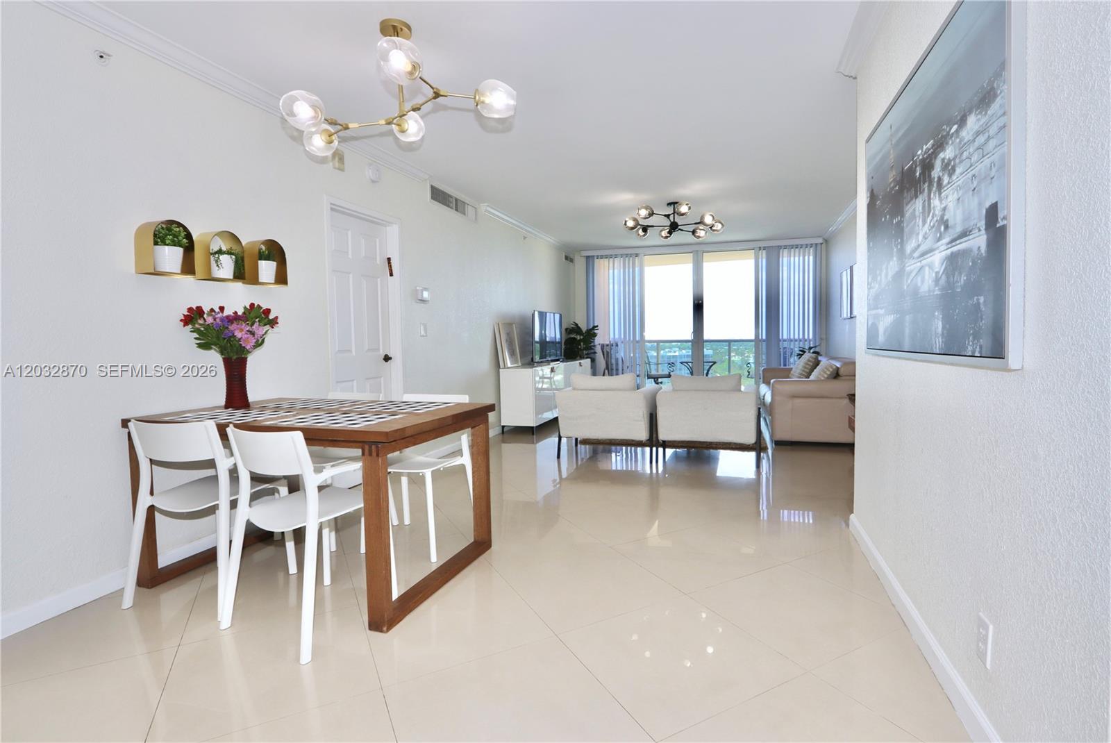 A bright, open-concept living and dining area features light tile flooring and modern light fixtures — 2501 S Ocean Dr # 1430, Hollywood FL 33019, HOLLYWOOD, FL