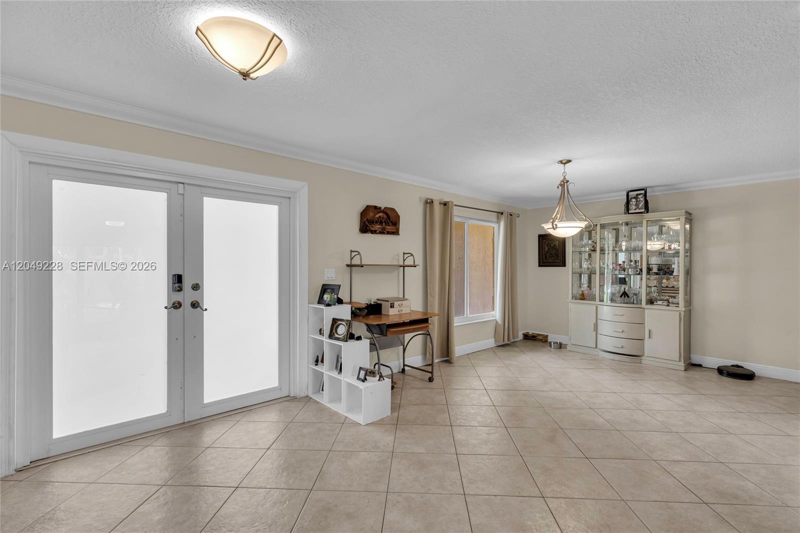 A dining area features tile flooring, a glass-front china cabinet, and double glass doors — 16740 Harbor Ct, Weston FL 33326, WESTON, FL