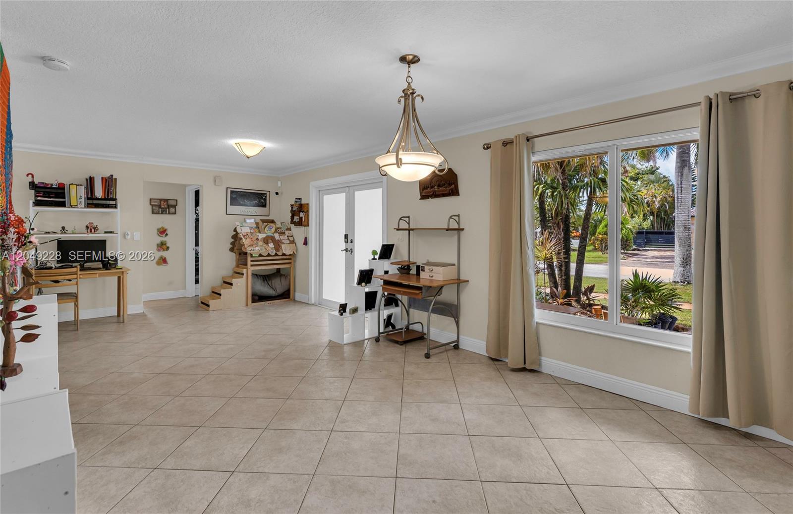 A bright, tiled living area features a desk, a pet house, and large windows — 16740 Harbor Ct, Weston FL 33326, WESTON, FL