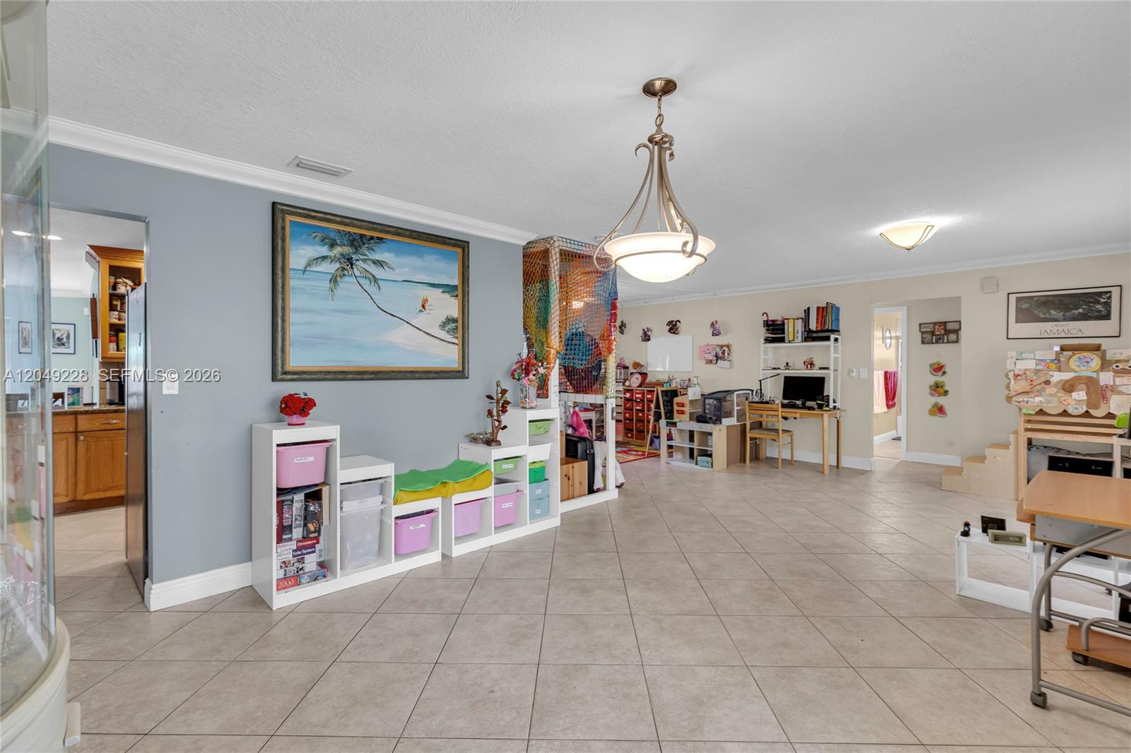 A spacious room with tile flooring, a large painting, storage cubbies, and a desk area — 16740 Harbor Ct, Weston FL 33326, WESTON, FL