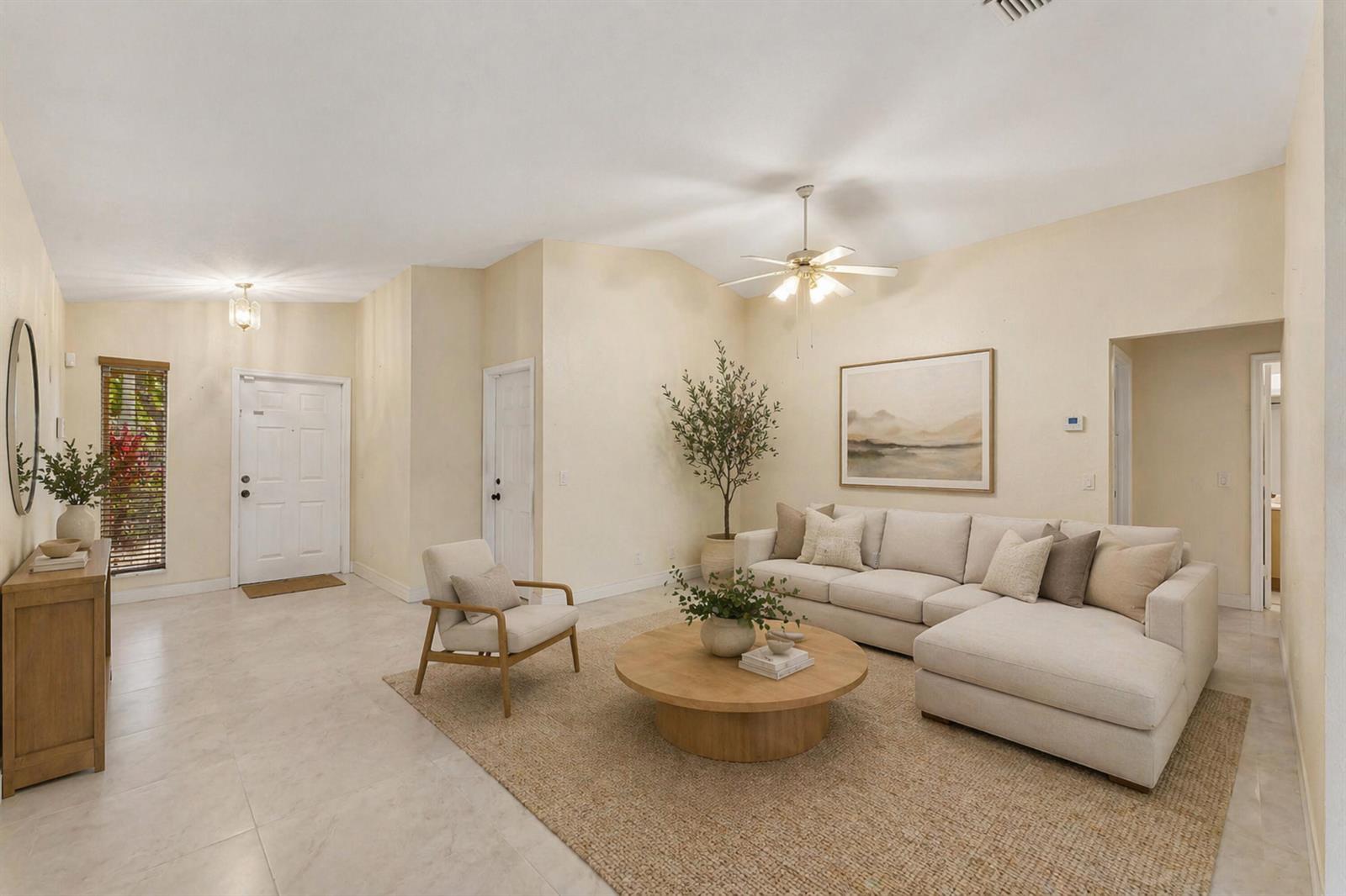 A living room features a beige sectional sofa, a round wooden coffee table, and tile flooring — 1353 Canary Island Drive, Weston FL 33327, WESTON, FL