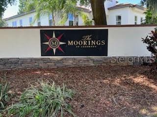 A sign for The Moorings of Clermont stands in front of a white building — 1825 MOORINGS COURT LOT 14, CLERMONT, FL