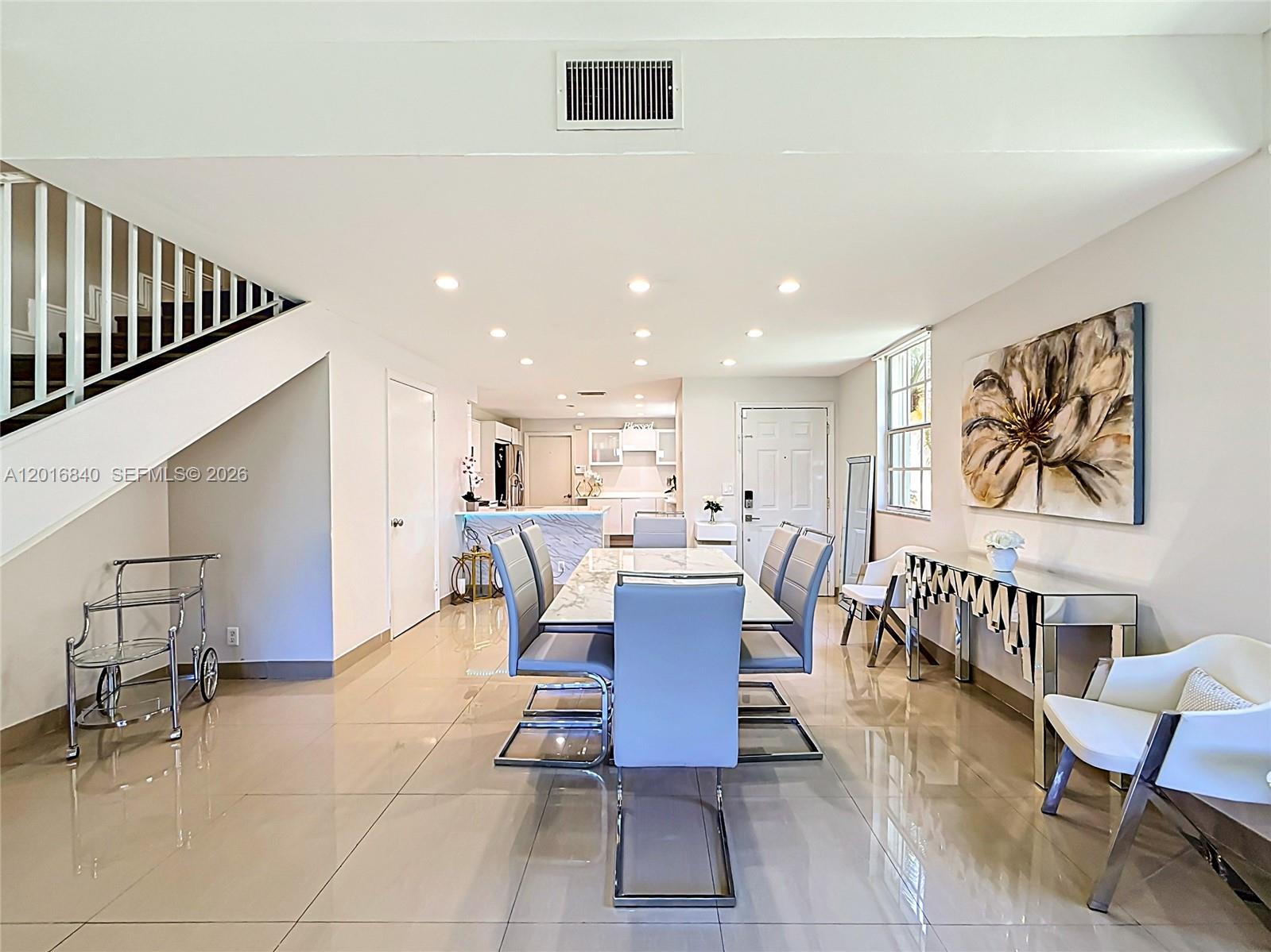 A dining area features a marble table, modern chairs, and a mirrored console table — 952 Sevilla Cir, Weston FL 33326, WESTON, FL