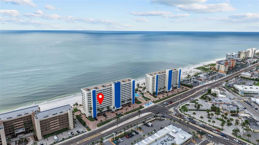 An aerial view shows a beachfront condominium building with a red location pin — 14950 GULF BOULEVARD UNIT 503, MADEIRA BEACH, FL