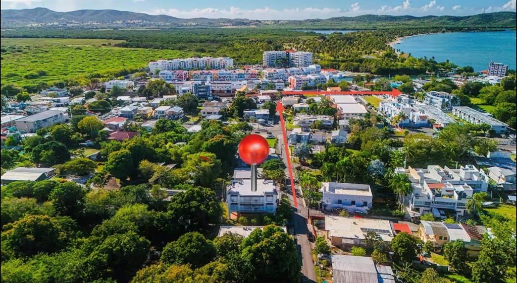 An aerial view shows a multi-story residential building marked with a red pin — Apt 202 MANUEL GUILLOTY / LIBREVATO MONTALVO UNIT 202, CABO ROJO, PR