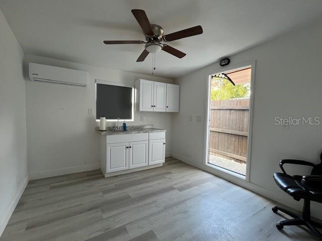 A room with white cabinets, a sink, a ceiling fan, and light wood-look flooring — 6708 N ARMENIA AVENUE, TAMPA, FL