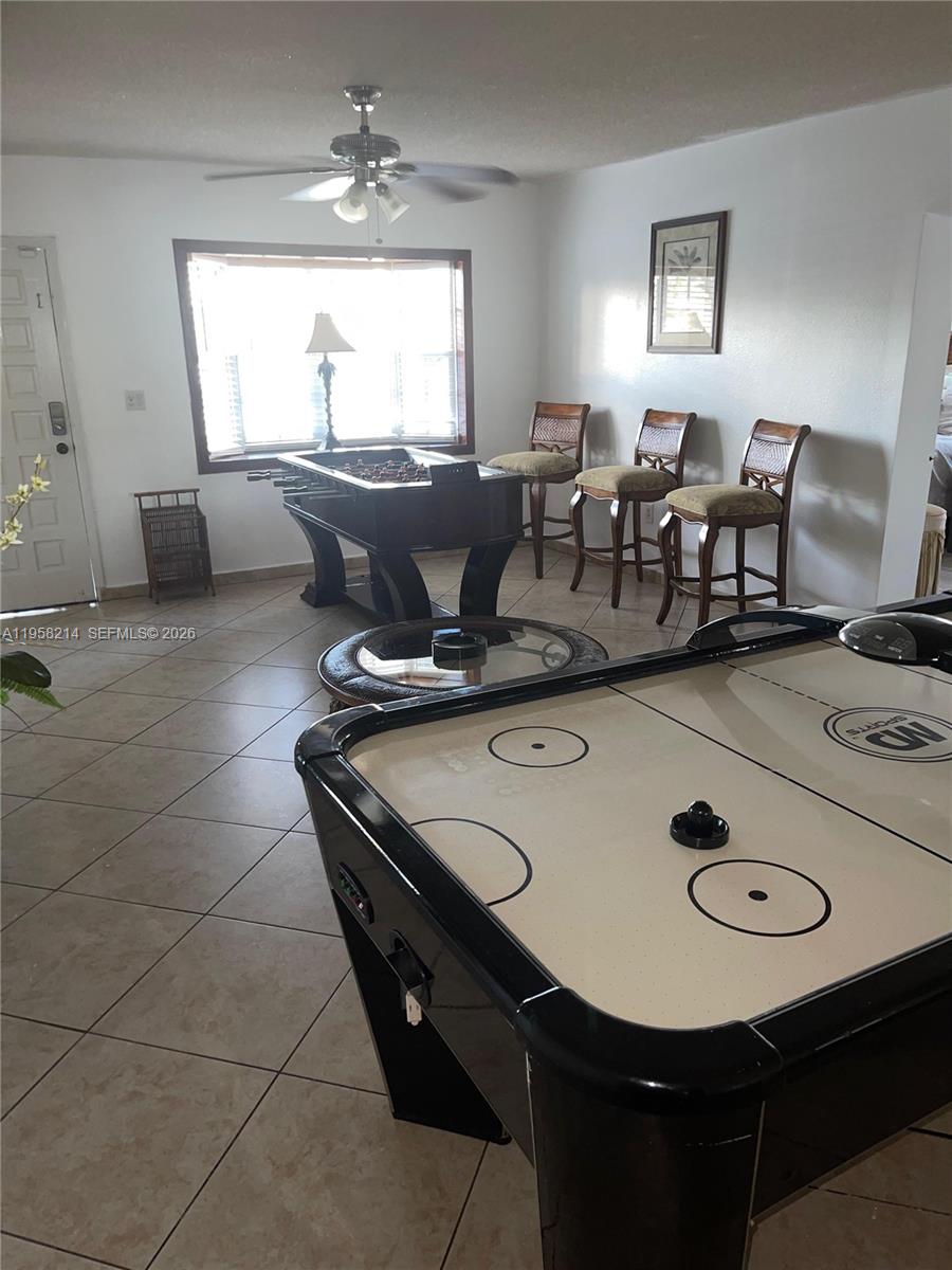 A game room features an air hockey table, a foosball table, and three bar stools — 6510 Park St, Hollywood FL 33024, HOLLYWOOD, FL