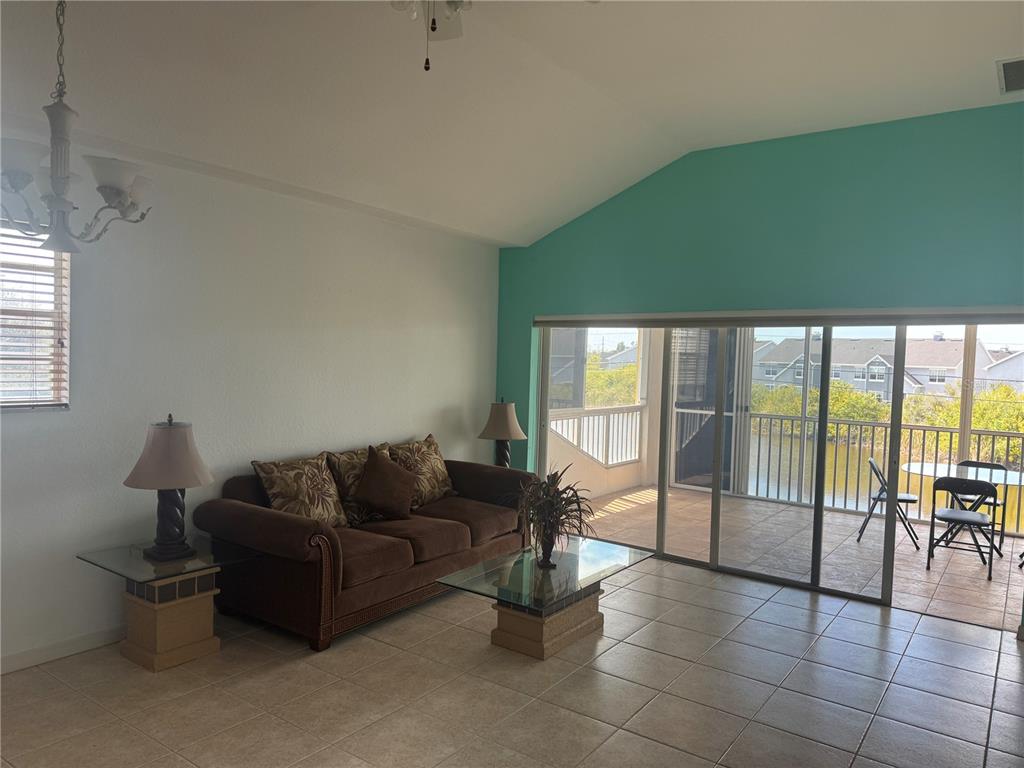 A backyard swimming pool with a white metal fence and patio furniture — 169 BOUNDARY BOULEVARD UNIT 169P, ROTONDA WEST, FL