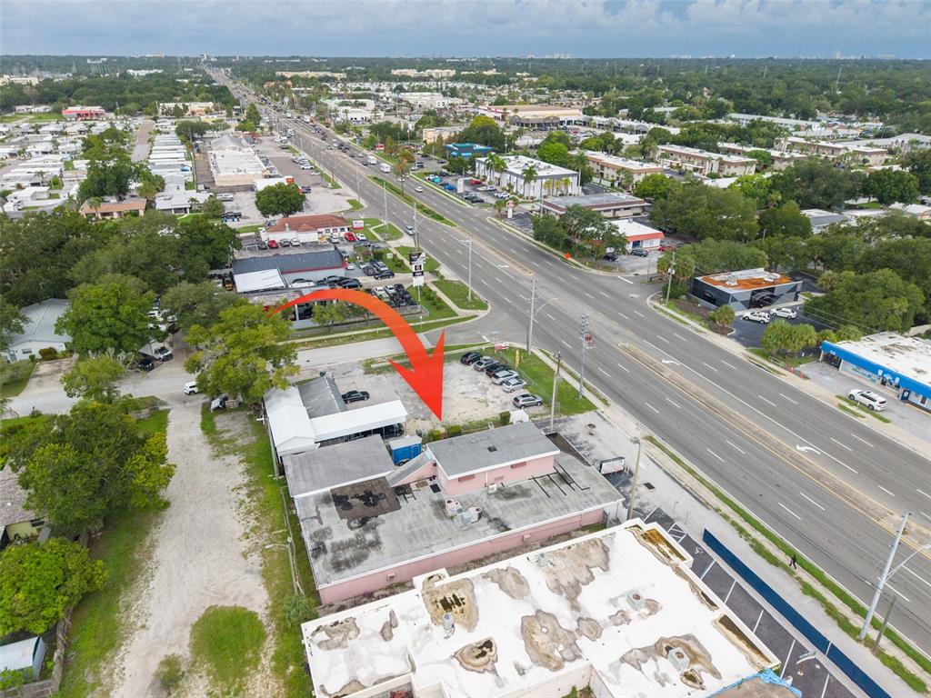 An aerial view shows a commercial building with a parking lot next to a highway — 2865 E BAY DRIVE, LARGO, FL