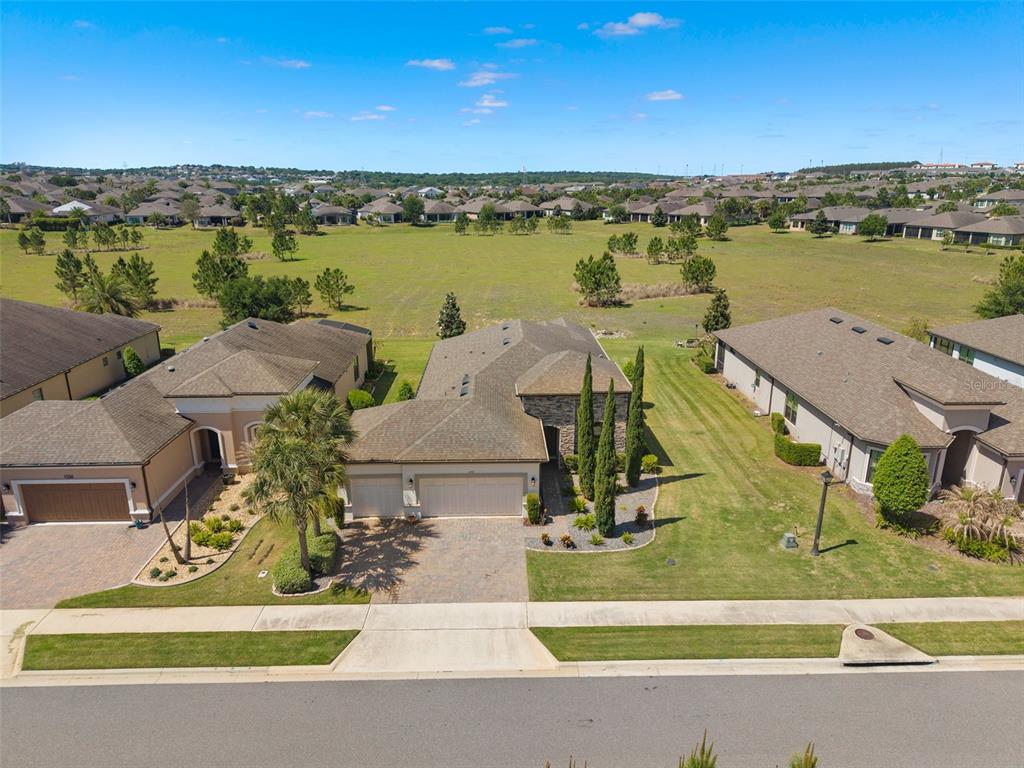 An aerial view of a suburban house with a paved driveway and a large backyard — 1222 ZEEK RIDGE STREET, CLERMONT, FL