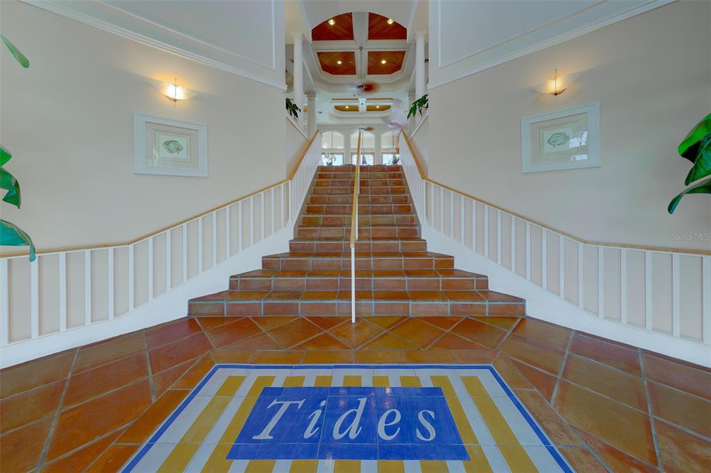 A tiled staircase with a central handrail leads to an upper level in a lobby — 16550 GULF BOULEVARD UNIT 342, NORTH REDINGTON BEACH, FL