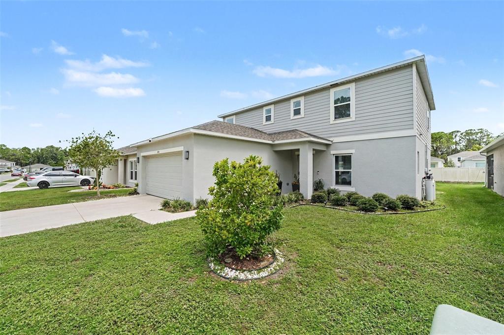 A two-story house with a gray exterior, a one-car garage, and a front lawn — 2051 ROSEWOOD CIRCLE, LAKELAND, FL