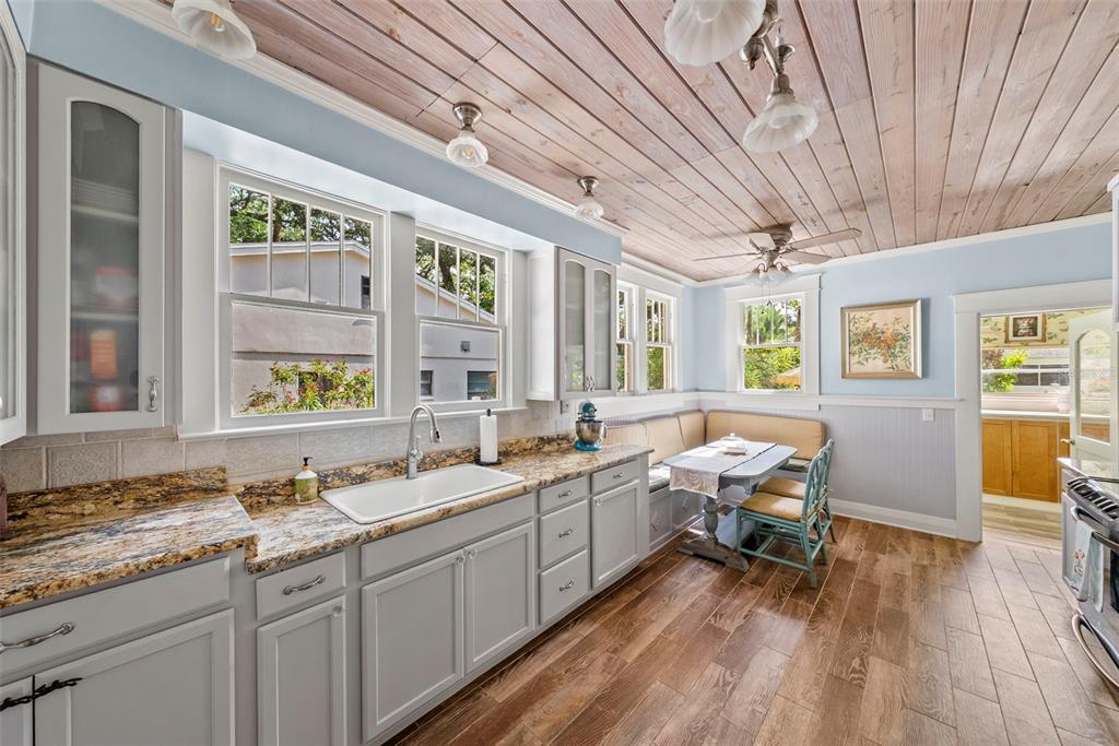 A kitchen with light gray cabinets, granite countertops, a breakfast nook, and wood-plank ceiling — 212 S COOLIDGE AVENUE, TAMPA, FL