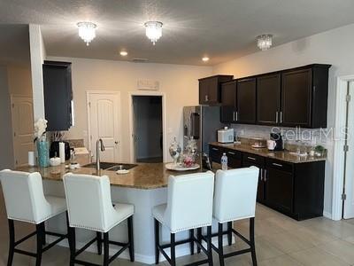 A single-story house with gray stucco, stone veneer accents, and a landscaped front yard — 5254 SE 91ST STREET, OCALA, FL