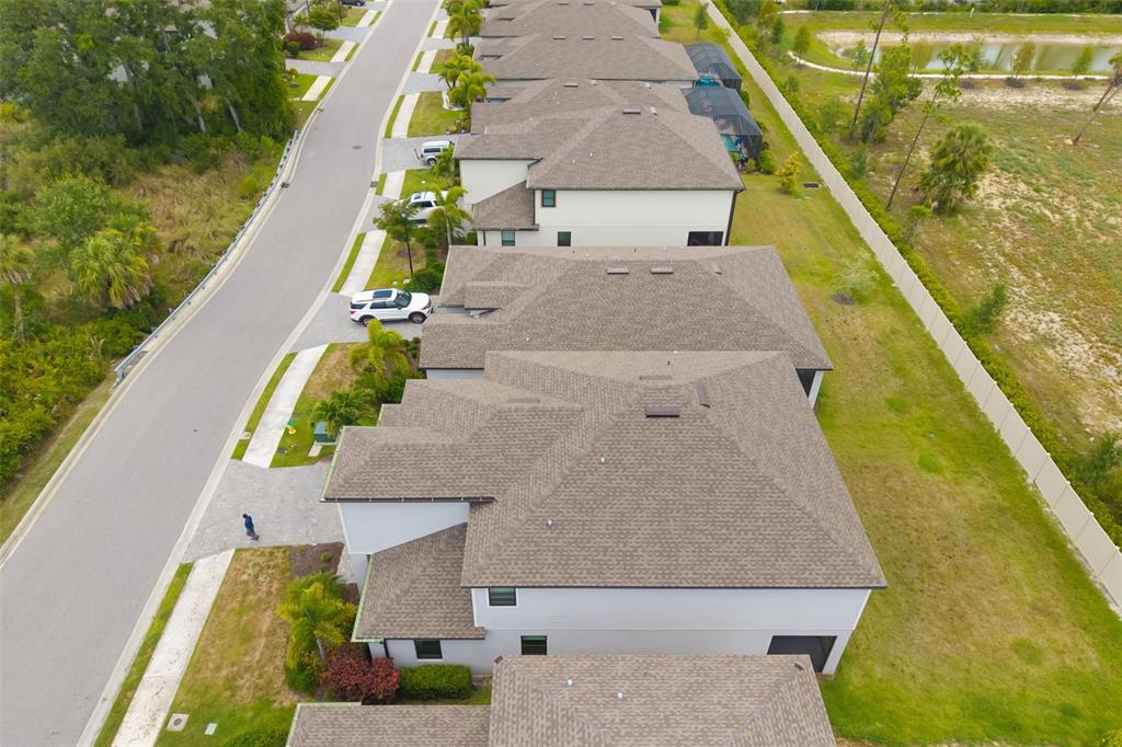 An aerial view shows a row of suburban houses with shingled roofs and driveways — 19524 FISHHAWK TRAIL, VENICE, FL
