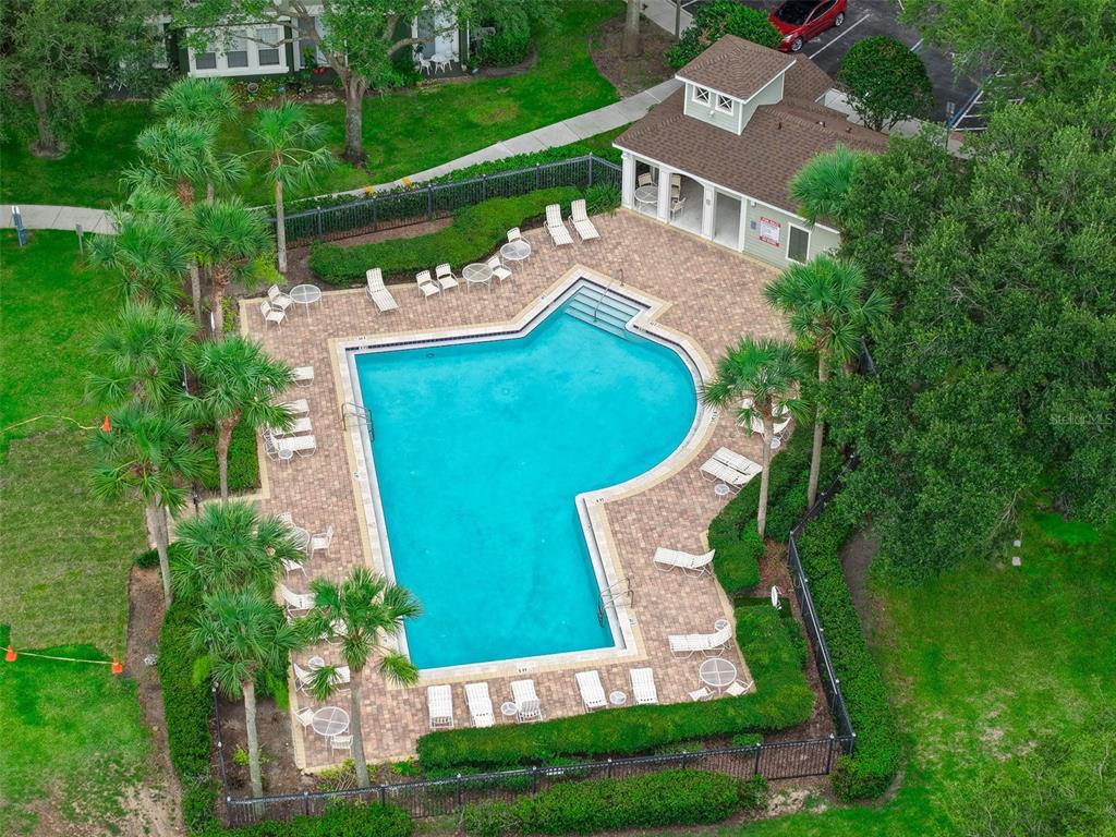 A tan two-story building exterior features a dark front door, a walkway, and landscaping — 870 ASHWORTH OVERLOOK DRIVE UNIT A, APOPKA, FL