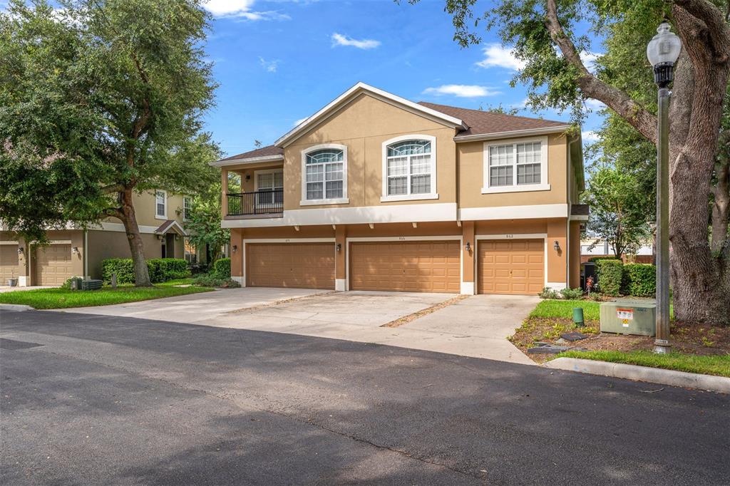 An aerial view of a community swimming pool surrounded by a brick patio and landscaping — 870 ASHWORTH OVERLOOK DRIVE UNIT A, APOPKA, FL
