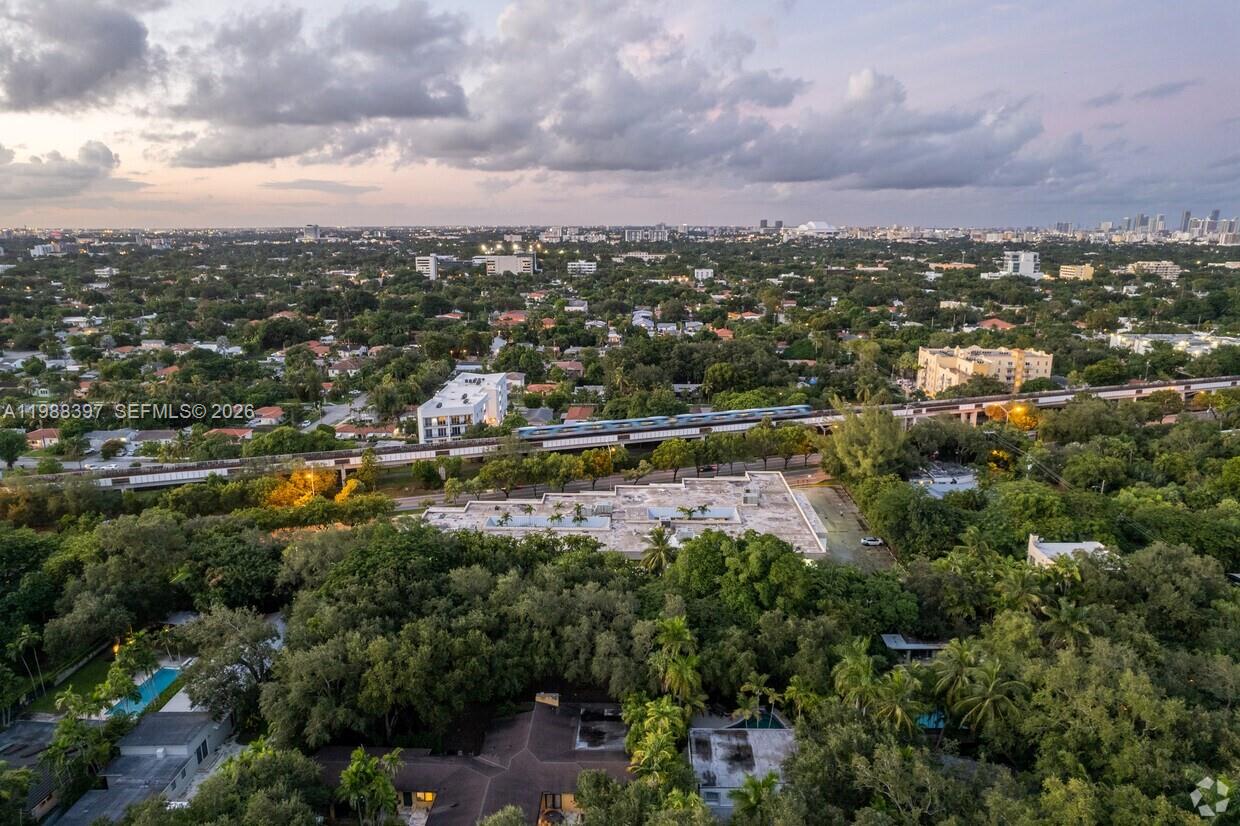 An aerial view shows a residential neighborhood with a train track and city skyline — 2000 S Dixie Hwy # 200, Miami FL 33133, MIAMI, FL