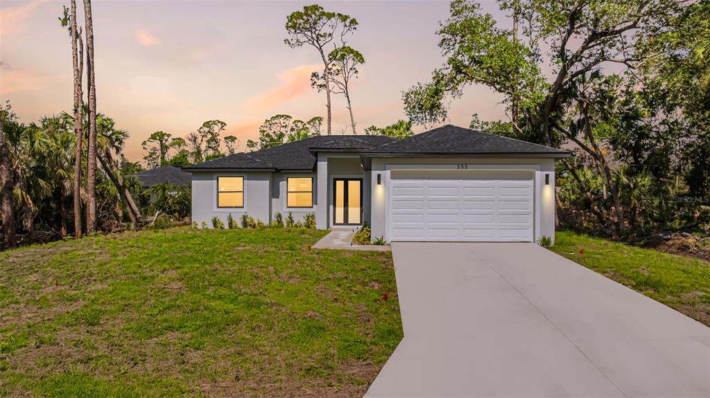 A single-story house with a white garage, gray exterior, and a concrete driveway — 355 MILTON STREET, PORT CHARLOTTE, FL