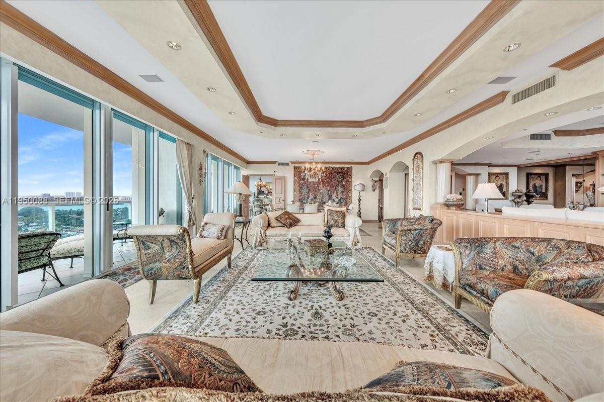 A spacious living room features ornate furniture, a large area rug, and floor-to-ceiling windows — 10101 Collins Ave # 16B, Bal Harbour FL 33154, BAL HARBOUR, FL