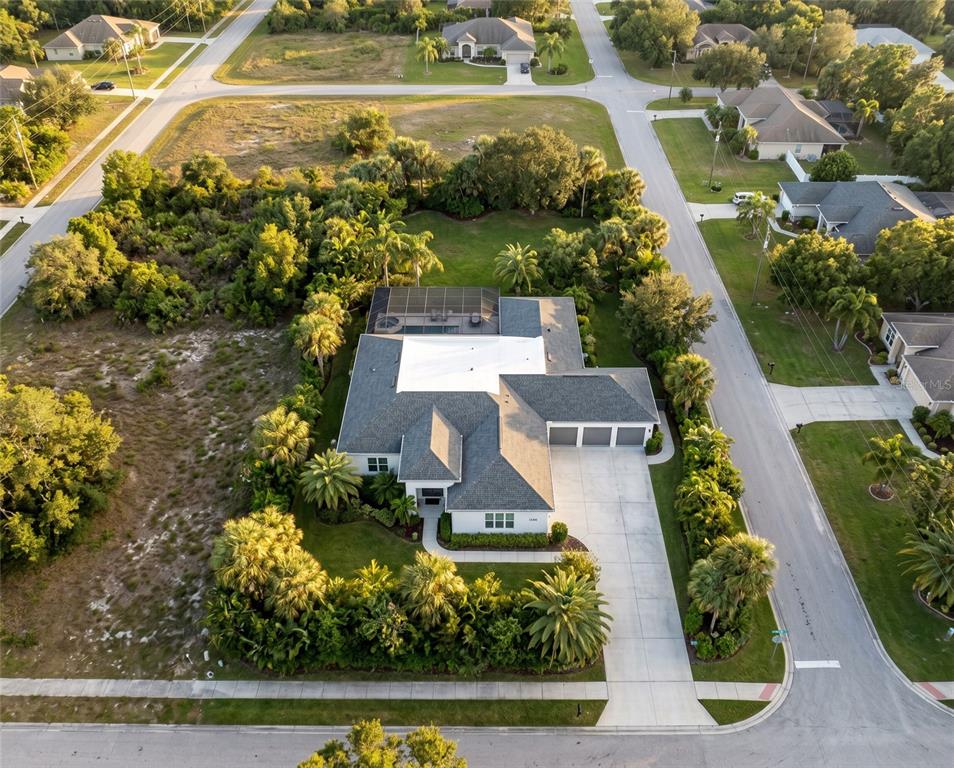 An aerial view shows a single-story house with a pool cage and a three-car garage — 1206 BUIST STREET, ORLANDO, FL