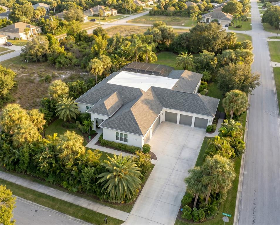 An aerial view of a single-story house with a three-car garage and pool enclosure — 1206 BUIST STREET, ORLANDO, FL