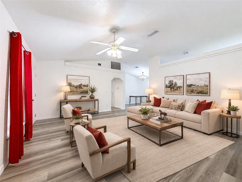 A living room features light wood-look flooring, a beige sectional sofa, and two armchairs — 13117 SW 33RD TERRACE, OCALA, FL